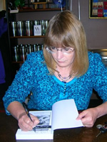 Sharon Edwards signing at Snake River Coffee